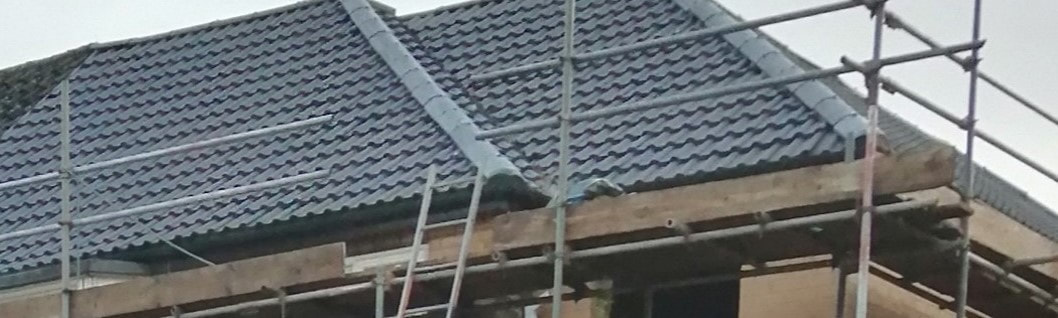 A picture of a hip roof installation with slate roof shingles by Roofers Sheffield